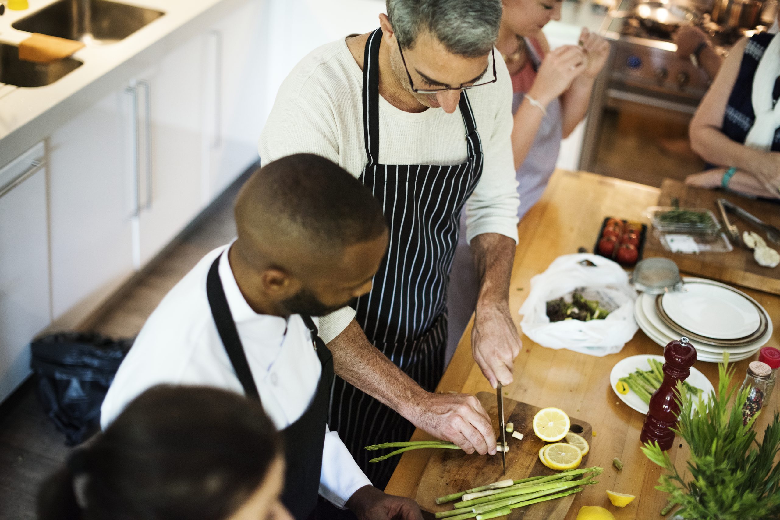 Group of friends cooking in the kitchen